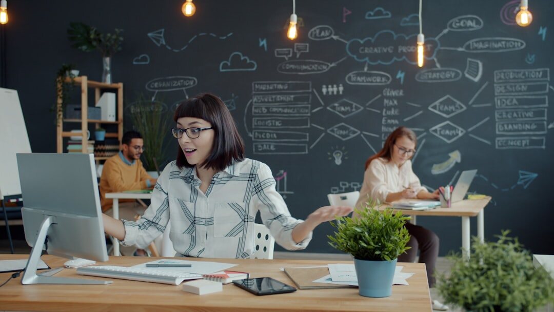 Startup team working on laptops in modern coworking space